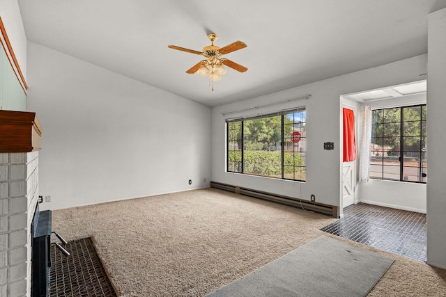 4100 Fort Peck St, Shasta Lake, CA 96019 - unfurnished living room featuring a baseboard radiator, carpet flooring, lofted ceiling, a ceiling fan, and a brick fireplace