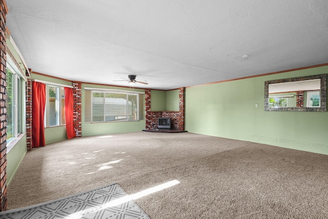 4100 Fort Peck St, Shasta Lake, CA 96019 - unfurnished living room featuring a ceiling fan, carpet flooring, a brick fireplace, a textured ceiling, and ornamental molding