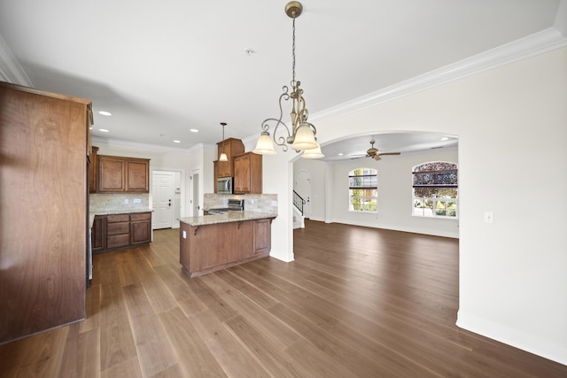 5569 Diamond Ridge Dr, Redding, CA 96003 - kitchen featuring range, open floor plan, a peninsula, stainless steel microwave, and a ceiling fan