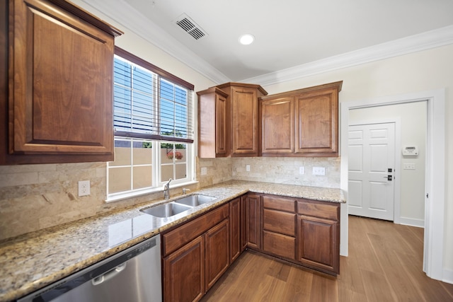 5569 Diamond Ridge Dr, Redding, CA 96003 - kitchen with stainless steel dishwasher, crown molding, wood finished floors, light stone countertops, and backsplash
