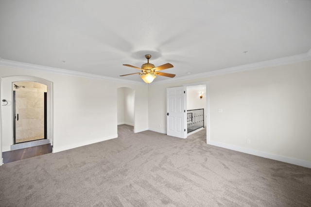 5569 Diamond Ridge Dr, Redding, CA 96003 - empty room with arched walkways, ornamental molding, carpet flooring, and a ceiling fan