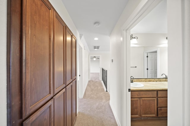 5569 Diamond Ridge Dr, Redding, CA 96003 - hallway featuring light colored carpet and crown molding