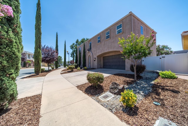 5569 Diamond Ridge Dr, Redding, CA 96003 - view of front of property with concrete driveway, a garage, a gate, and stucco siding