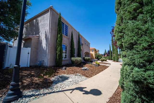 5569 Diamond Ridge Dr, Redding, CA 96003 - view of property exterior with stucco siding and a gate