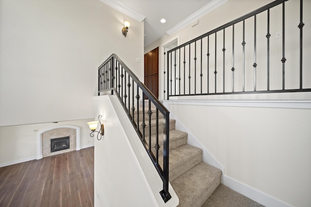 5569 Diamond Ridge Dr, Redding, CA 96003 - stairs featuring crown molding, a tile fireplace, wood finished floors, and recessed lighting