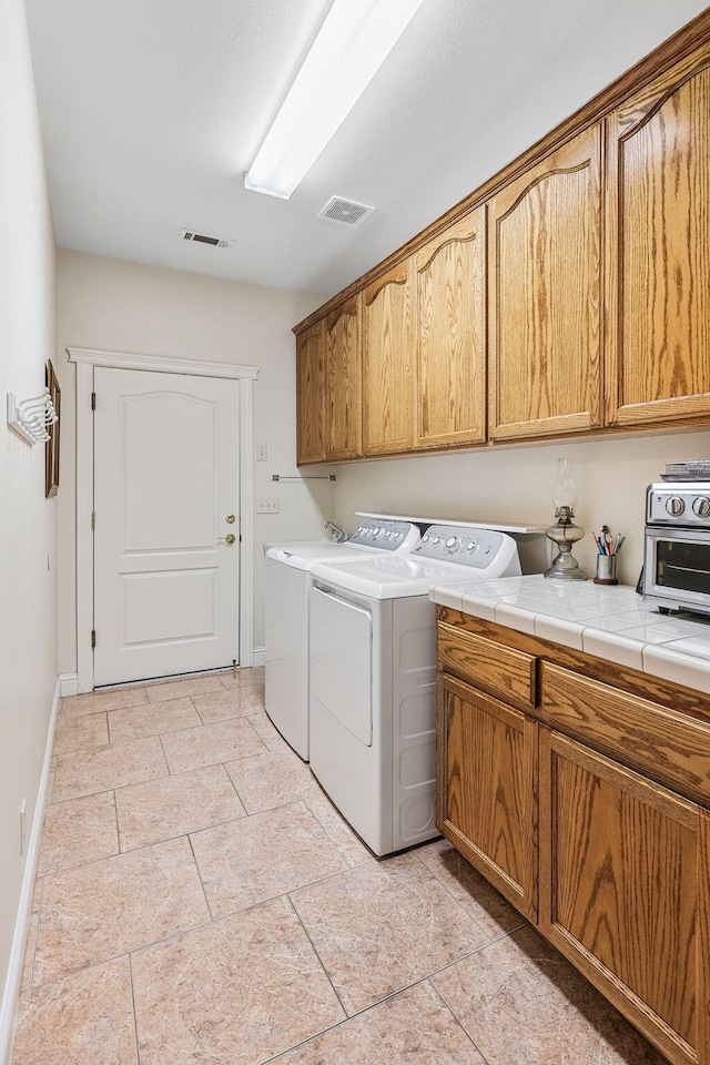 1533 Spanish Bay Dr, Redding, CA 96003 - washroom with separate washer and dryer and cabinet space