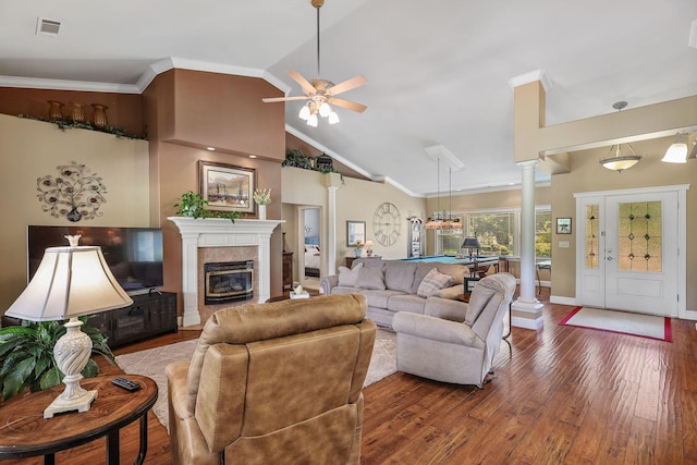 1533 Spanish Bay Dr, Redding, CA 96003 - living room featuring decorative columns, wood finished floors, a ceiling fan, a tiled fireplace, and crown molding