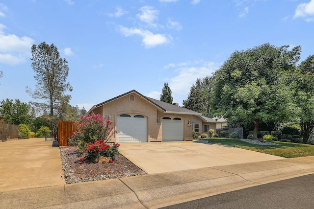 1533 Spanish Bay Dr, Redding, CA 96003 - ranch-style home featuring an attached garage, concrete driveway, and stucco siding