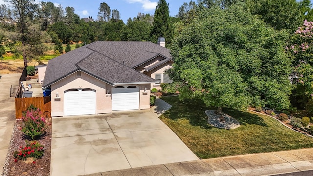 1533 Spanish Bay Dr, Redding, CA 96003 - view of front facade with concrete driveway, a shingled roof, stucco siding, an attached garage, and a chimney
