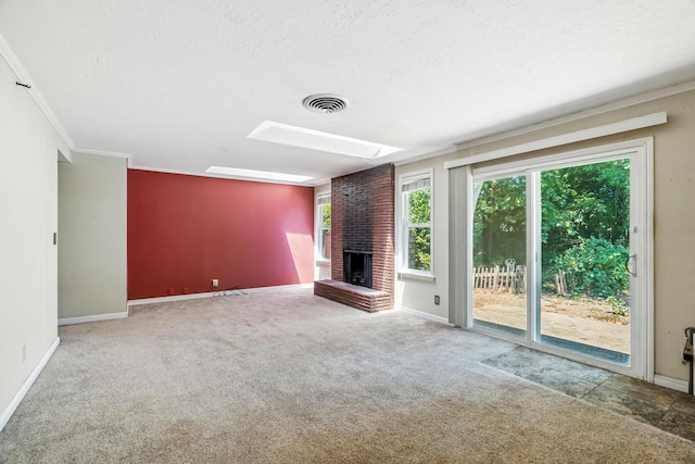 1198 Denton Way, Redding, CA 96002 - unfurnished living room with a fireplace, a skylight, carpet floors, crown molding, and a textured ceiling