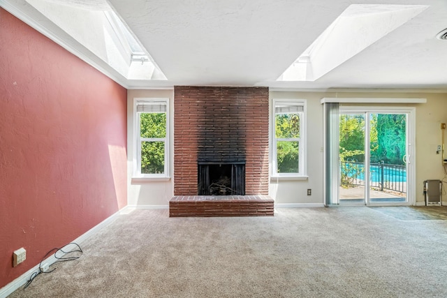 1198 Denton Way, Redding, CA 96002 - unfurnished living room featuring carpet flooring, a skylight, a brick fireplace, and a textured wall
