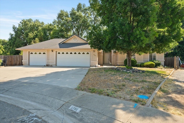 2790 Citrine Ave, Redding, CA 96001 - view of front of home featuring stucco siding, a garage, and driveway
