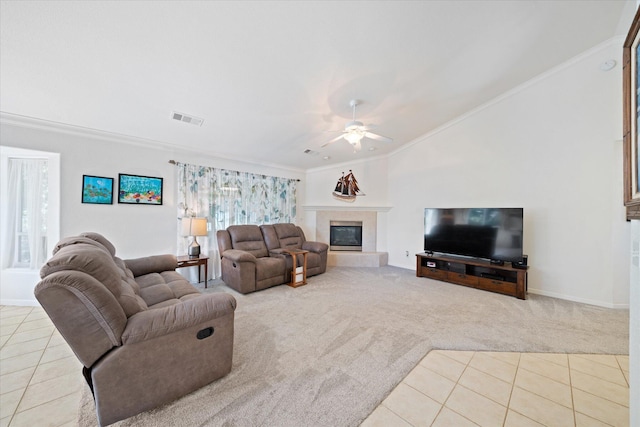 2790 Citrine Ave, Redding, CA 96001 - carpeted living area with tile patterned floors, ornamental molding, vaulted ceiling, ceiling fan, and a tiled fireplace