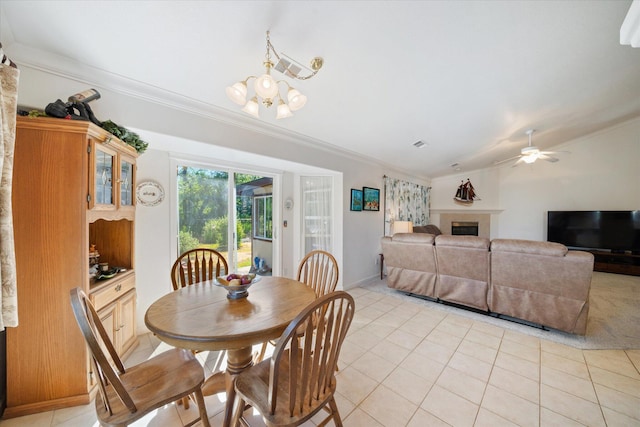 2790 Citrine Ave, Redding, CA 96001 - dining area with crown molding, a chandelier, light tile patterned floors, a tile fireplace, and a ceiling fan