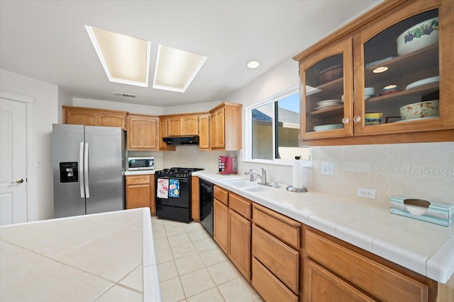 2790 Citrine Ave, Redding, CA 96001 - kitchen featuring black appliances, exhaust hood, backsplash, and glass insert cabinets