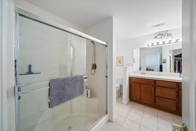 2790 Citrine Ave, Redding, CA 96001 - full bath featuring vanity, a stall shower, tile patterned flooring, and a walk in closet