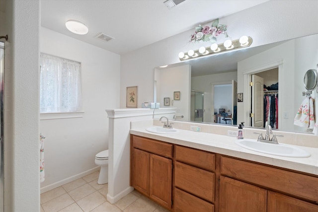 2790 Citrine Ave, Redding, CA 96001 - bathroom featuring a walk in closet, double vanity, a shower stall, and tile patterned flooring