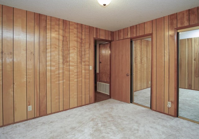 30839 Tinkerbell Ln, Shingletown, CA 96088 - unfurnished bedroom featuring carpet flooring, a textured ceiling, and wood walls