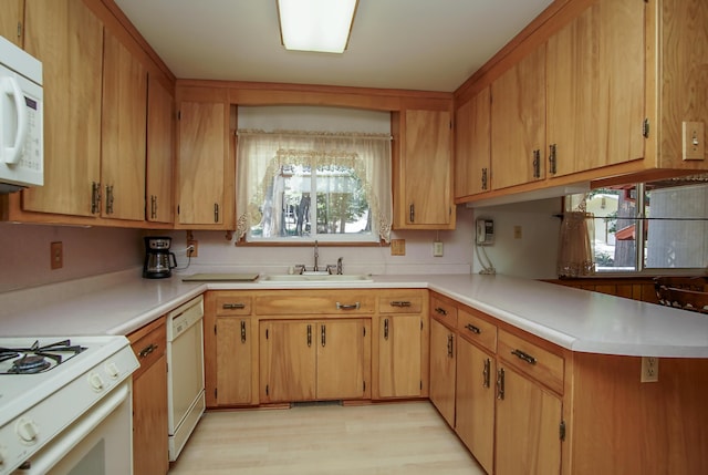 30839 Tinkerbell Ln, Shingletown, CA 96088 - kitchen with white appliances, light countertops, light wood finished floors, and a peninsula