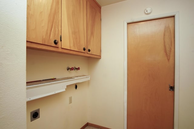 30839 Tinkerbell Ln, Shingletown, CA 96088 - laundry room featuring electric dryer hookup and cabinet space