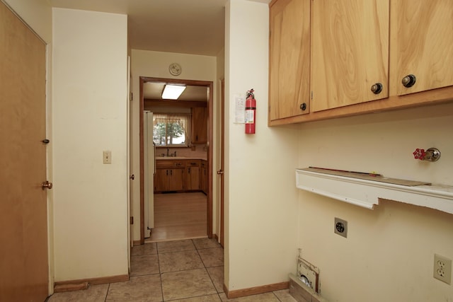 30839 Tinkerbell Ln, Shingletown, CA 96088 - washroom with electric dryer hookup, cabinet space, and light tile patterned floors