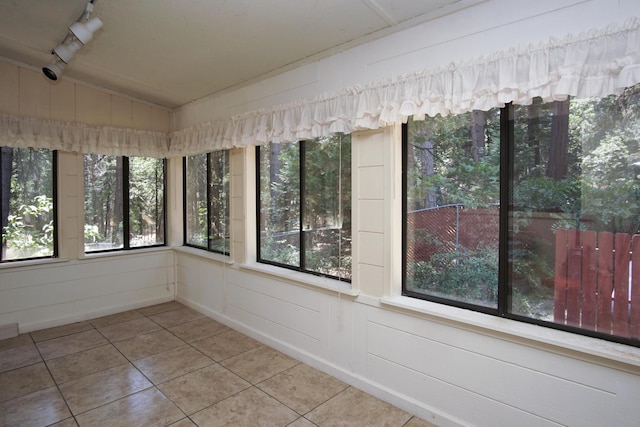 30839 Tinkerbell Ln, Shingletown, CA 96088 - unfurnished sunroom with tile patterned flooring, lofted ceiling, and a decorative wall
