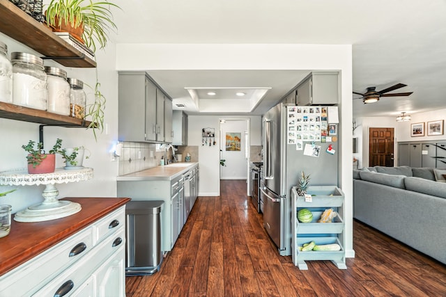 4020 Oro St, Redding, CA 96001 - kitchen featuring a raised ceiling, open floor plan, a ceiling fan, gray cabinetry, and dark wood finished floors