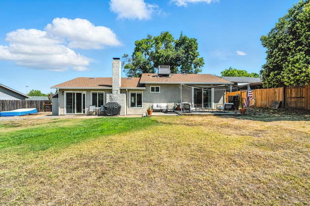 4020 Oro St, Redding, CA 96001 - rear view of house featuring a patio, a fenced backyard, a chimney, stucco siding, and an outdoor living space