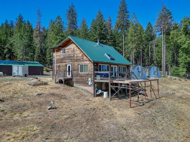 311 Ward Placer Pl, Weaverville, CA 96093 - back of property with an outdoor structure, a forest view, and a metal roof