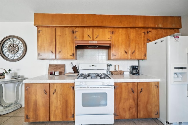 2045 Washington Ave, Red Bluff, CA 96080 - kitchen with white appliances, premium range hood, brown cabinets, decorative backsplash, and light countertops