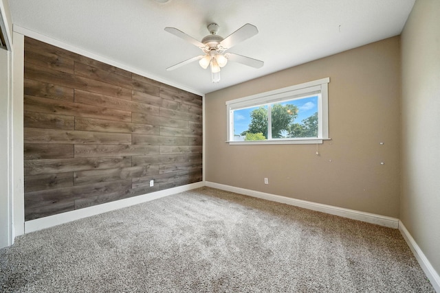 2045 Washington Ave, Red Bluff, CA 96080 - carpeted empty room with wood walls and ceiling fan