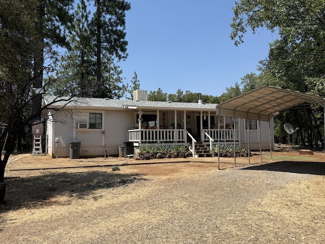 11941 Atkins Rd, Whitmore, CA 96096 - manufactured / mobile home with dirt driveway, a detached carport, and covered porch