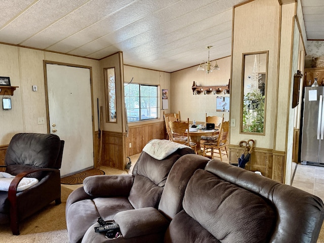 11941 Atkins Rd, Whitmore, CA 96096 - living room with wood walls, a wainscoted wall, lofted ceiling, ornamental molding, and a chandelier