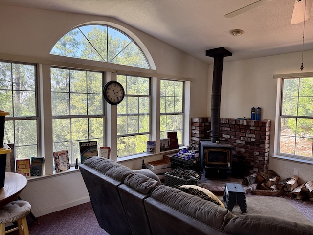 11941 Atkins Rd, Whitmore, CA 96096 - carpeted living area with a wood stove, vaulted ceiling, and ceiling fan