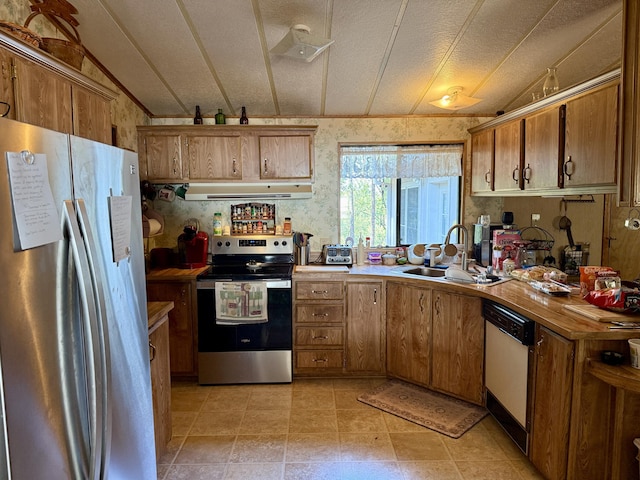 11941 Atkins Rd, Whitmore, CA 96096 - kitchen featuring stainless steel appliances, exhaust hood, brown cabinetry, and lofted ceiling