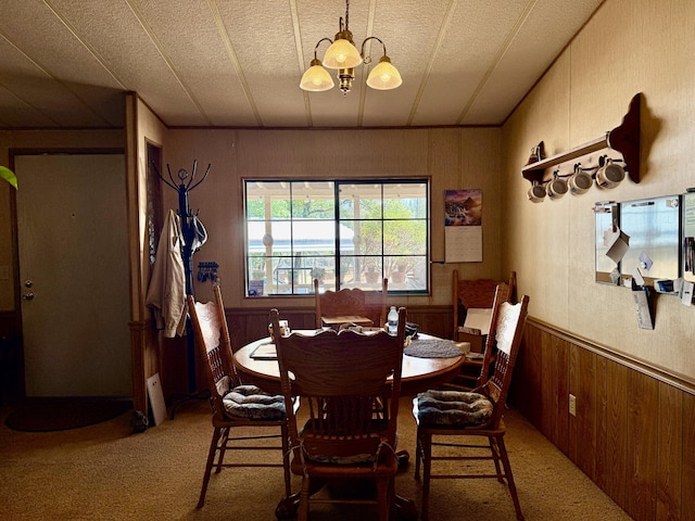 11941 Atkins Rd, Whitmore, CA 96096 - dining space with light carpet, wooden walls, and a wainscoted wall