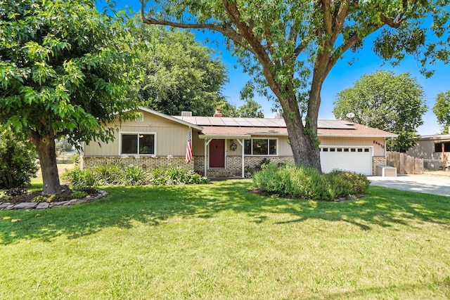 24470 Oklahoma Ave, Red Bluff, CA 96080 - ranch-style house with a garage, concrete driveway, solar panels, brick siding, and a chimney