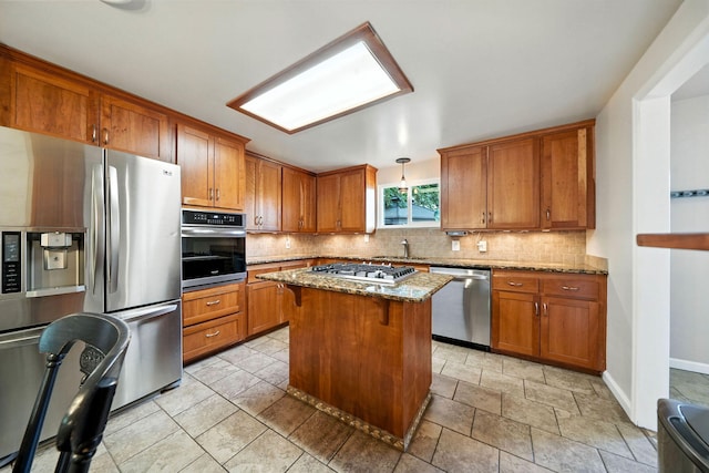 24470 Oklahoma Ave, Red Bluff, CA 96080 - kitchen with appliances with stainless steel finishes, brown cabinets, and tasteful backsplash