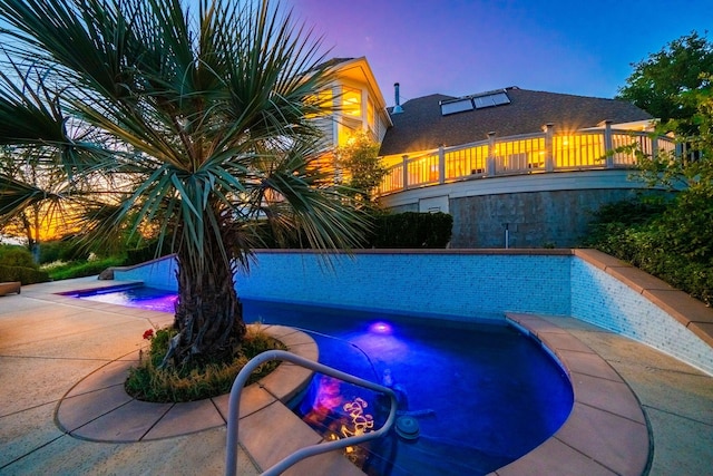23795 Deer Canyon Rd, Millville, CA 96062 - pool at dusk featuring a jacuzzi, an outdoor pool, and a patio area