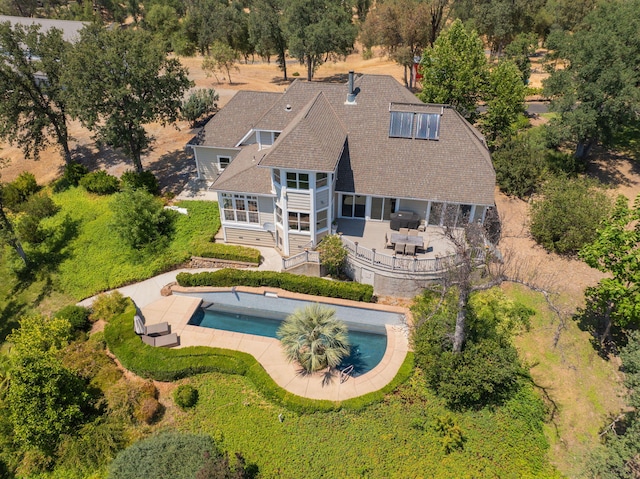 23795 Deer Canyon Rd, Millville, CA 96062 - rear view of house with a patio area, a sunroom, outdoor dining area, an outdoor pool, and roof with shingles