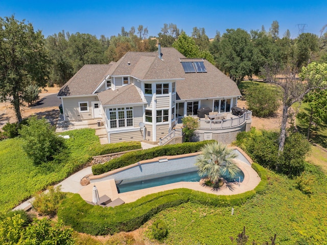 23795 Deer Canyon Rd, Millville, CA 96062 - rear view of house with roof mounted solar panels, an outdoor pool, a patio area, stairway, and a deck