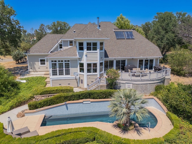 23795 Deer Canyon Rd, Millville, CA 96062 - back of property featuring solar panels, a deck, an outdoor pool, a shingled roof, and a patio
