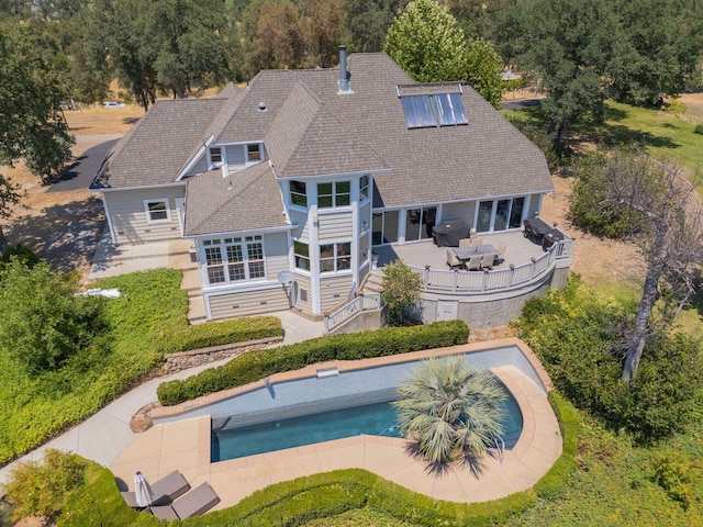23795 Deer Canyon Rd, Millville, CA 96062 - back of house featuring an outdoor pool, outdoor dining space, a deck, a shingled roof, and a patio area