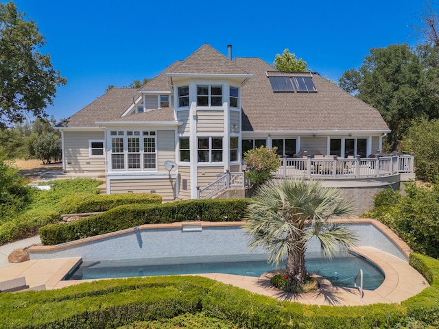 23795 Deer Canyon Rd, Millville, CA 96062 - rear view of house with a wooden deck, an outdoor pool, roof with shingles, and solar panels