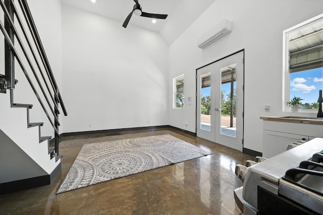 23795 Deer Canyon Rd, Millville, CA 96062 - entrance foyer with an AC wall unit, french doors, a ceiling fan, concrete flooring, and stairway