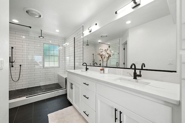 23795 Deer Canyon Rd, Millville, CA 96062 - bathroom featuring double vanity, tile patterned flooring, a tile shower, and recessed lighting
