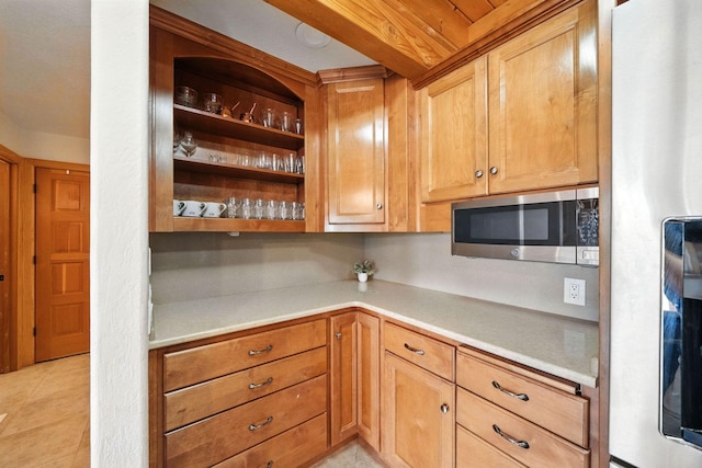 23795 Deer Canyon Rd, Millville, CA 96062 - kitchen with fridge, stainless steel microwave, light countertops, and light tile patterned floors