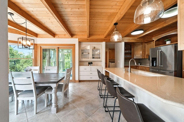23795 Deer Canyon Rd, Millville, CA 96062 - kitchen with high quality fridge, open shelves, light tile patterned floors, a wood ceiling with exposed beams, and light countertops