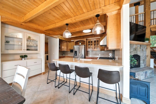 23795 Deer Canyon Rd, Millville, CA 96062 - kitchen featuring a wood ceiling with exposed beams, stainless steel fridge, light countertops, a peninsula, and light tile patterned floors