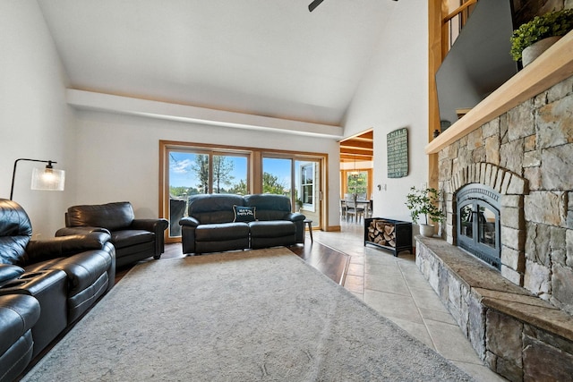 23795 Deer Canyon Rd, Millville, CA 96062 - living area featuring high vaulted ceiling, a fireplace, a ceiling fan, and tile patterned floors